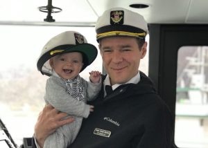 Captain Cody Hanna holding his son Ezra