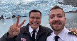 Shore Operations Manager Matt with Vessel Operations Manager Johnny in front of a glacier