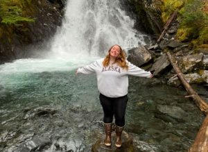 Lead Deckhand Noel in front of a waterfall