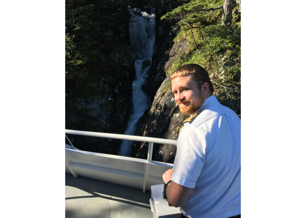 Captain Ian operating the boat by a waterfall